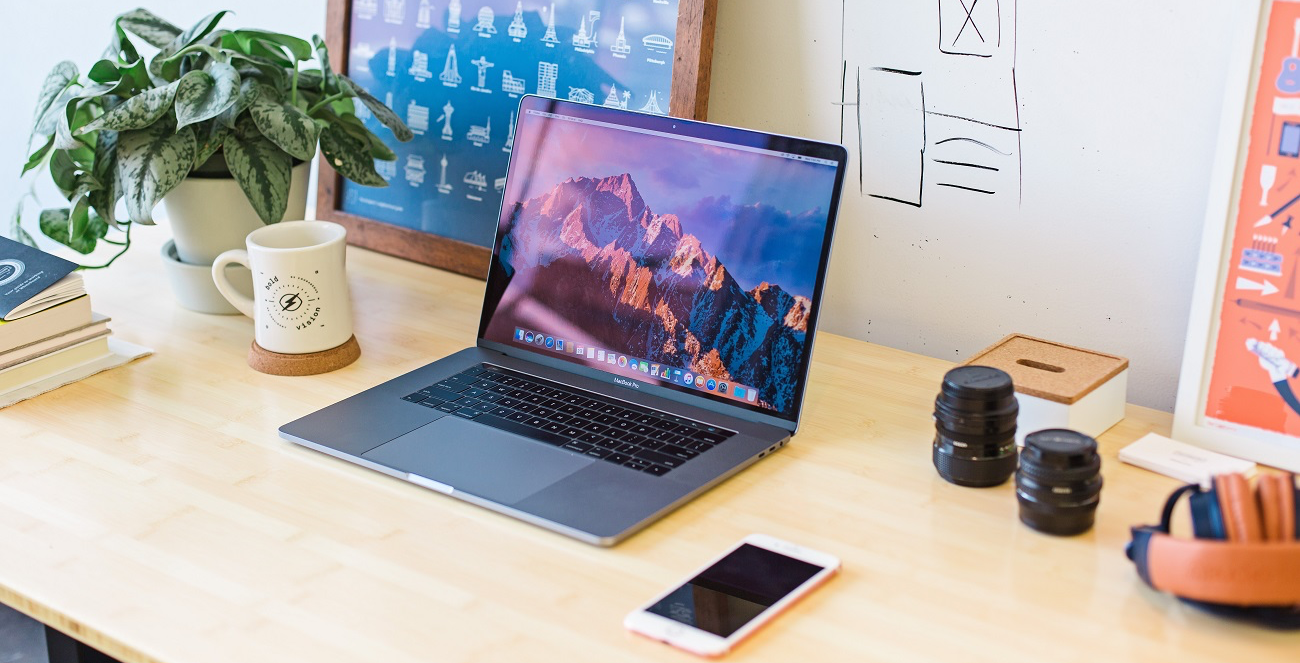 desk with a laptop and headphones