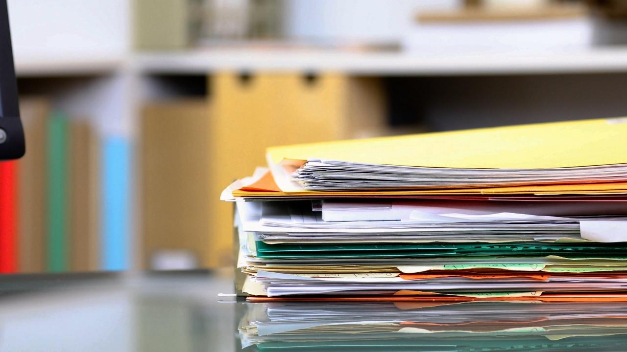 Documents stacked on office desk