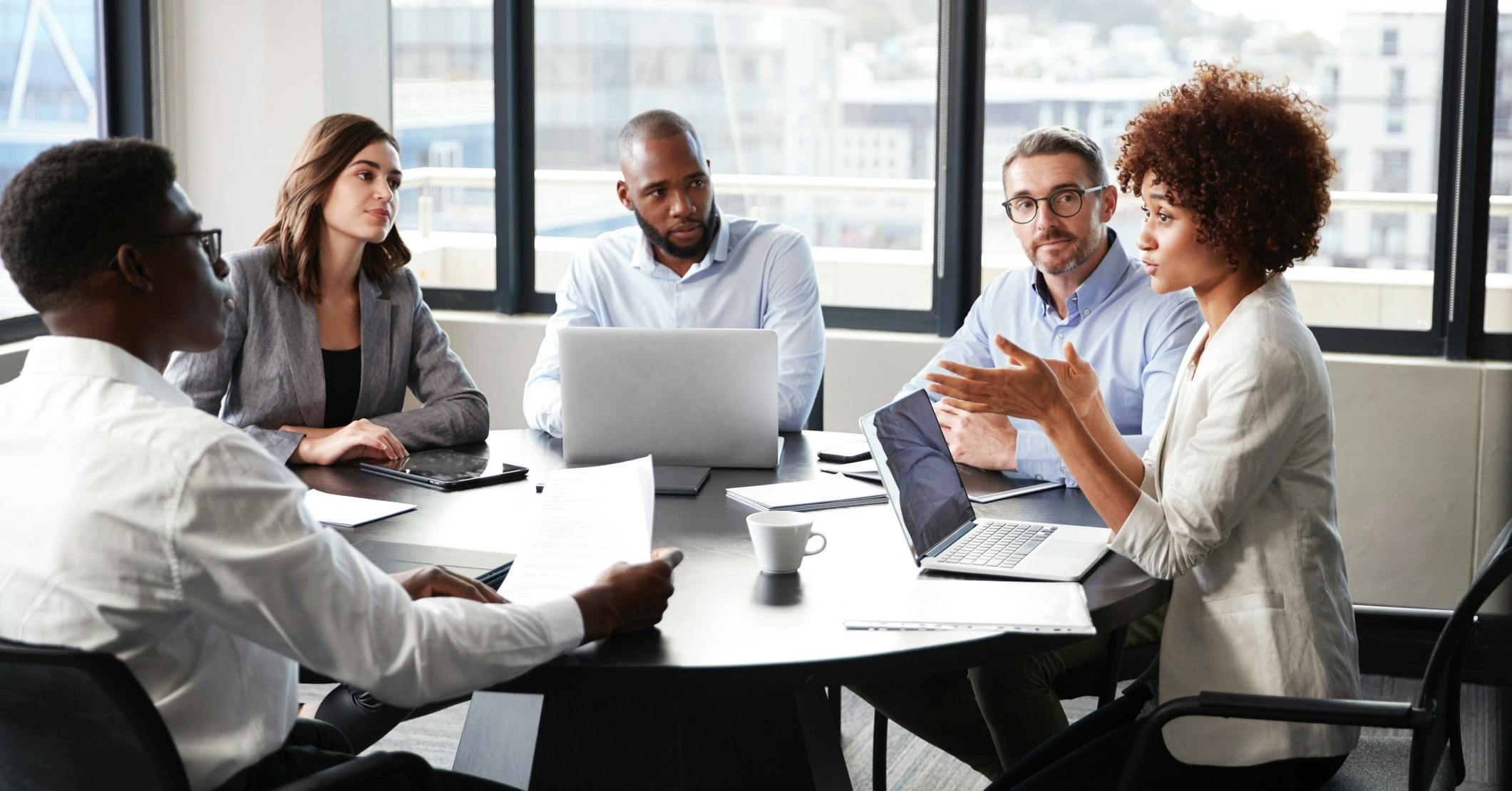 Business woman advising board members in office