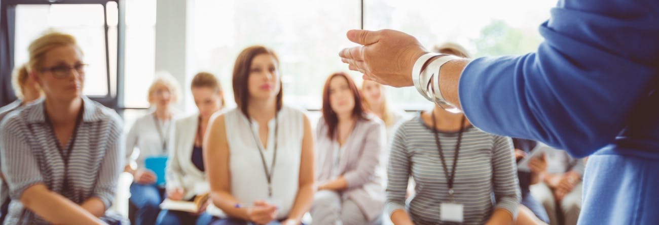 Professionals listening to instructor during training