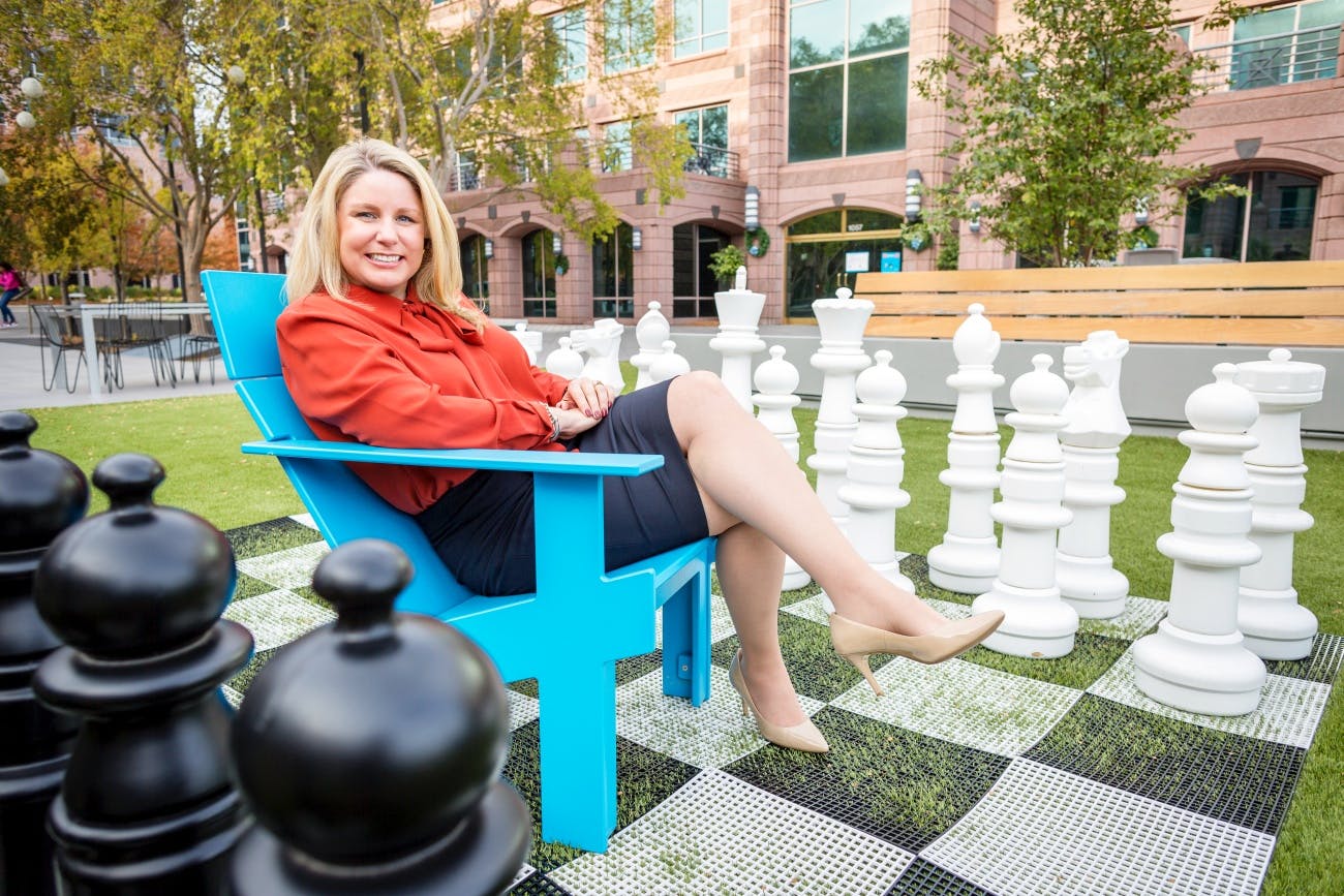 Tina Renee McCall sitting on outdoor chess set