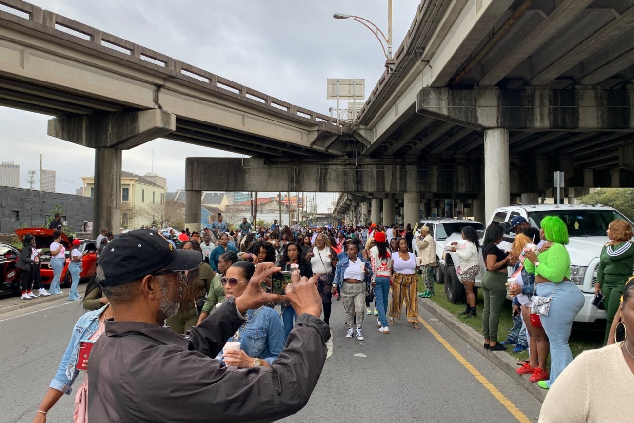 Gold Second Line Sunday Parade under viaduct