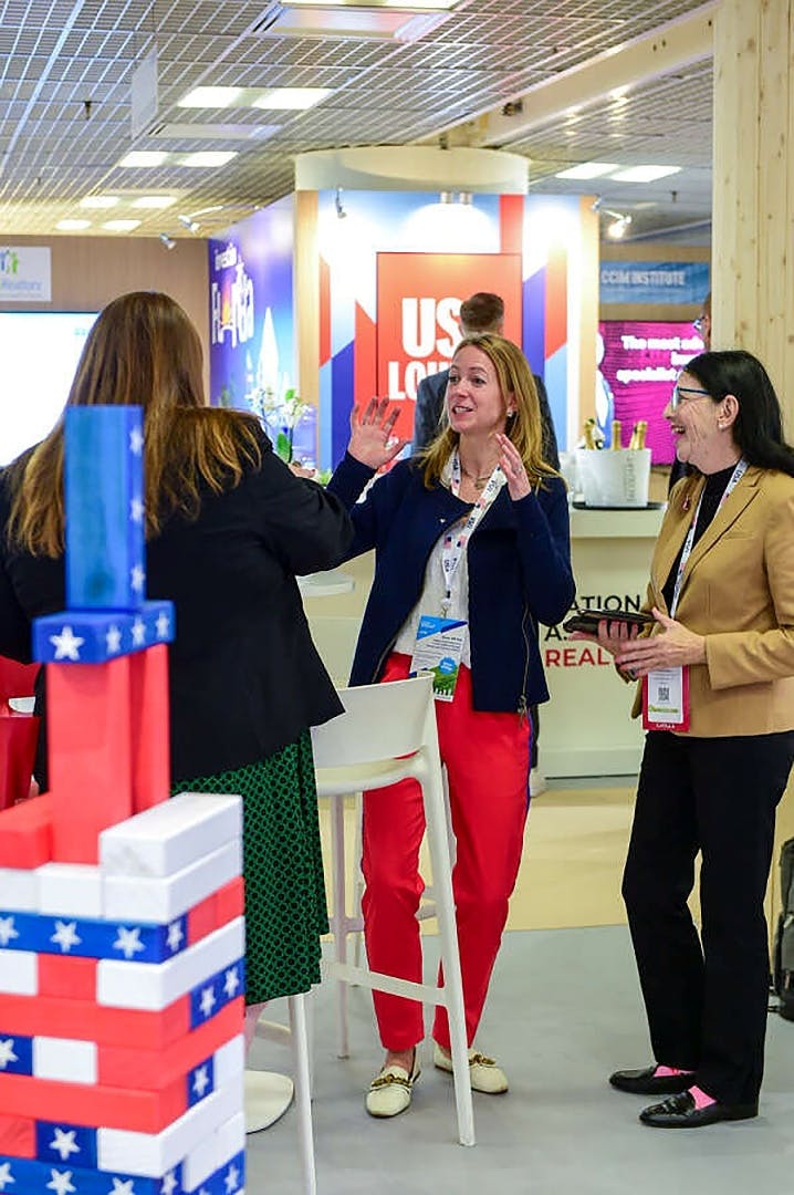 MIPIM 2024: three women colleagues talking by USA pavilion