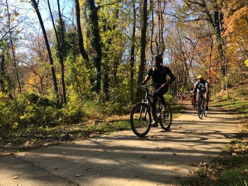 People riding their bicycles on the Baltimore Herring Run Trail