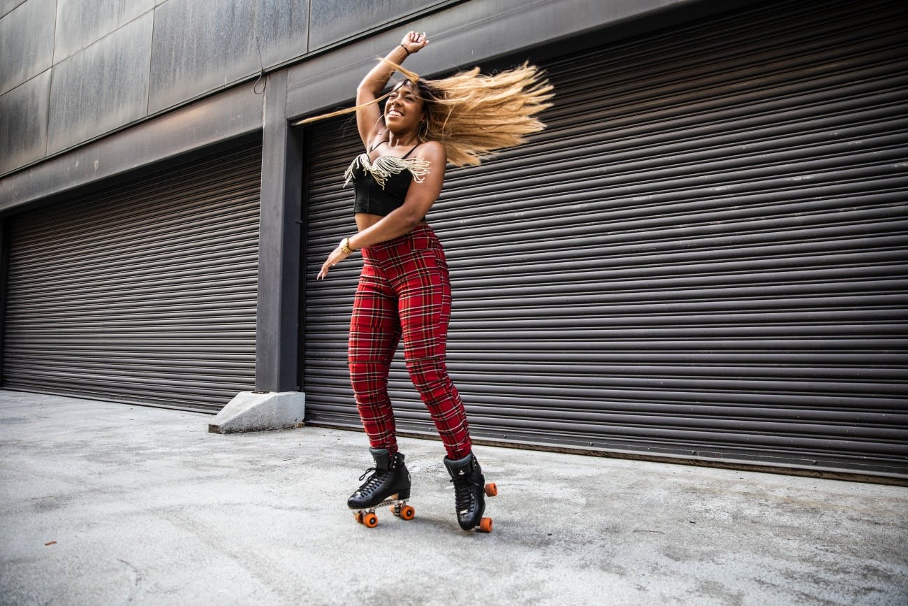 Young woman rollerskating in urban area