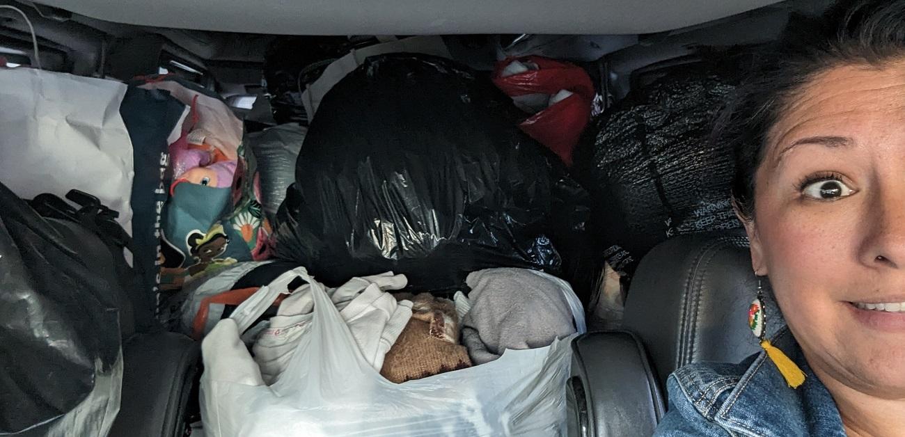 REALTOR Erika Villegas with bags of essential for migrant families in Chicago