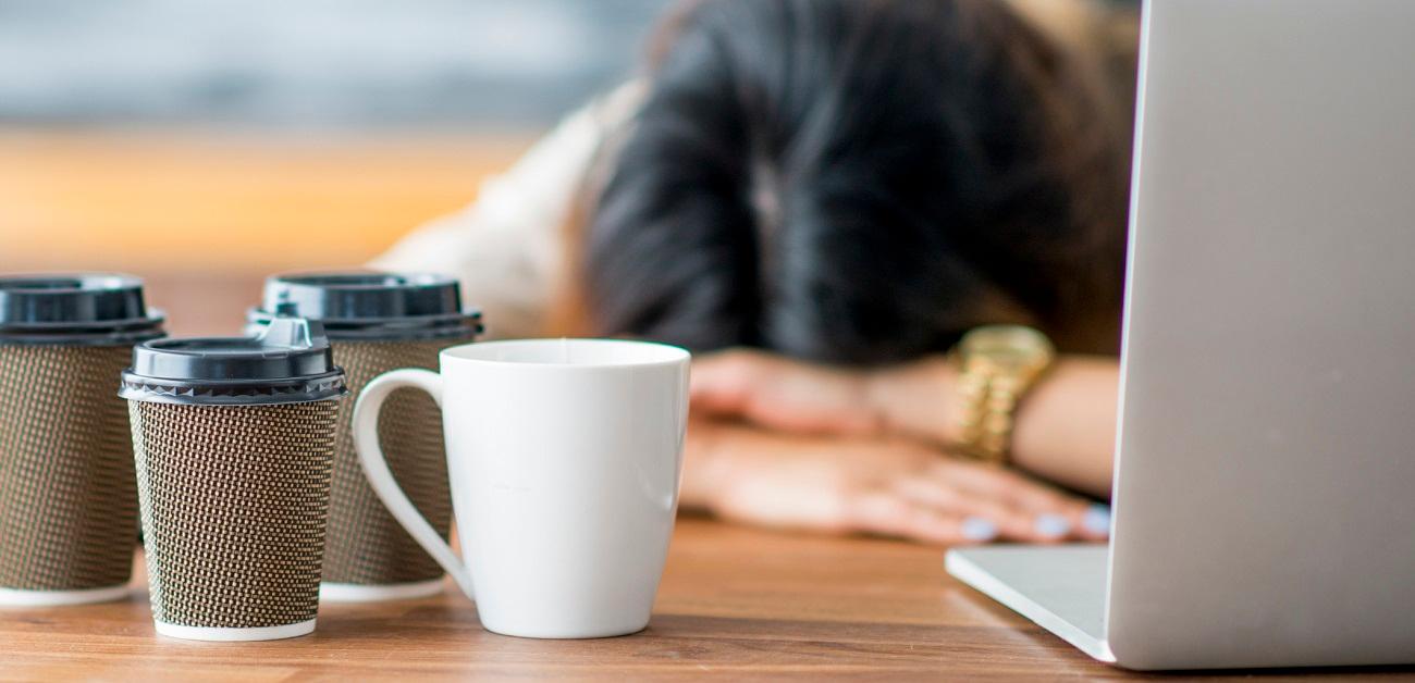 Exhausted person at desk