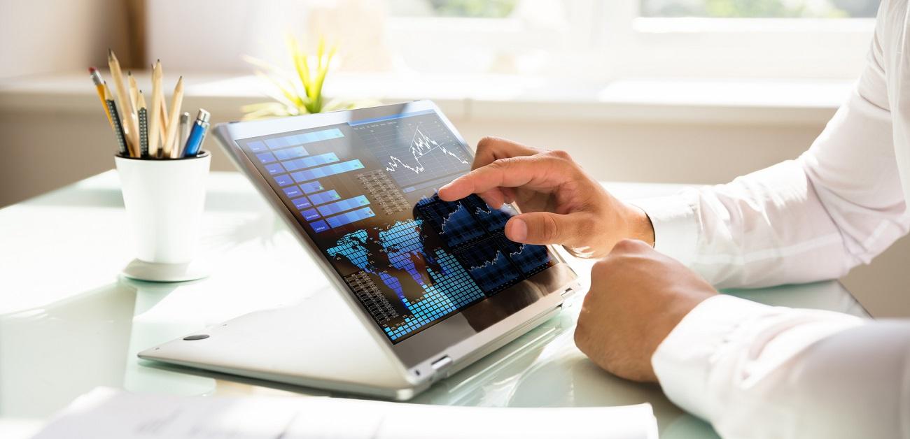 Businessman analyzing graph on laptop