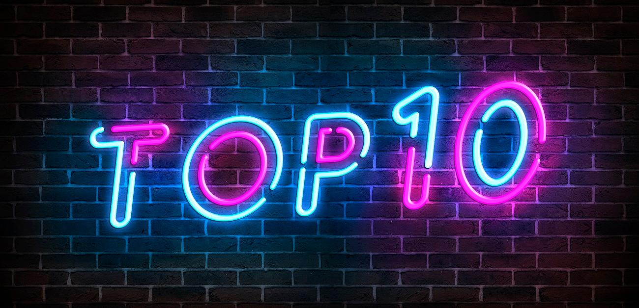 Top 10 neon blue and pink light text on empty red brick wall