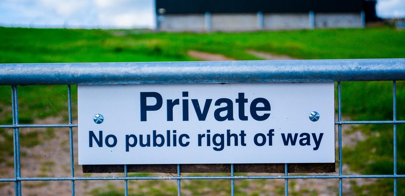 Private sign on fence around farmland