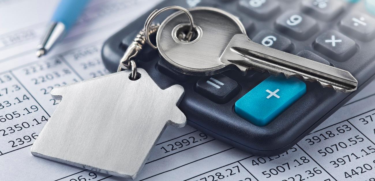 Key with house on keychain and calculator