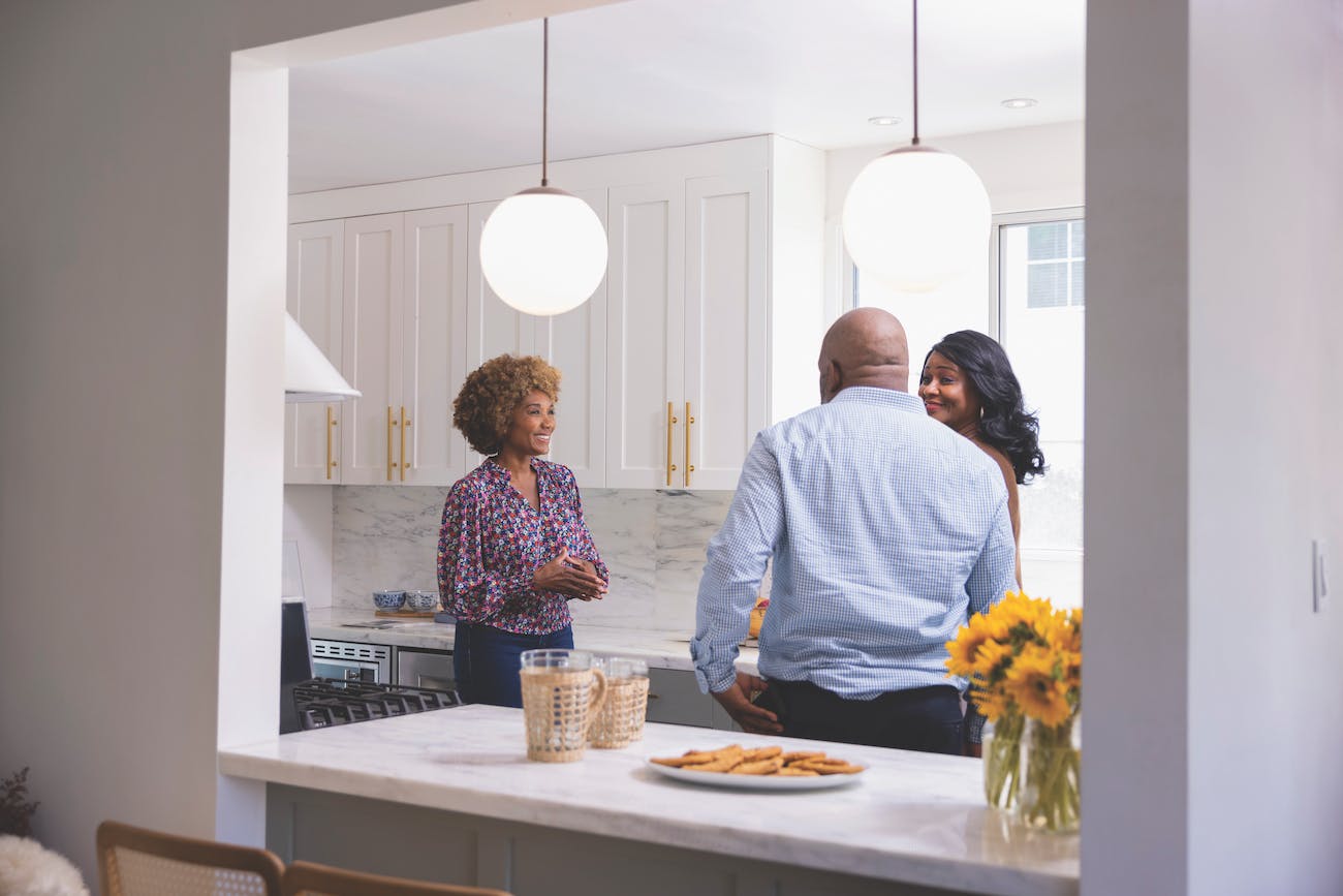 Real Estate Agent Walking a Couple Through a Home Listing 