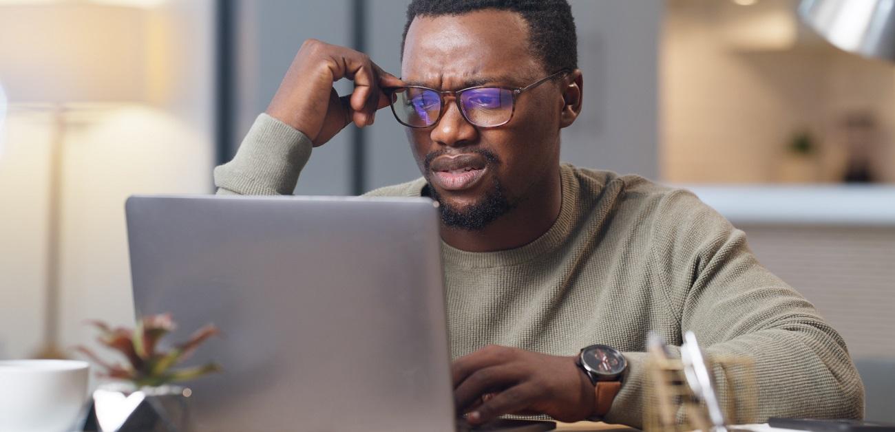 Frustrated man using computer