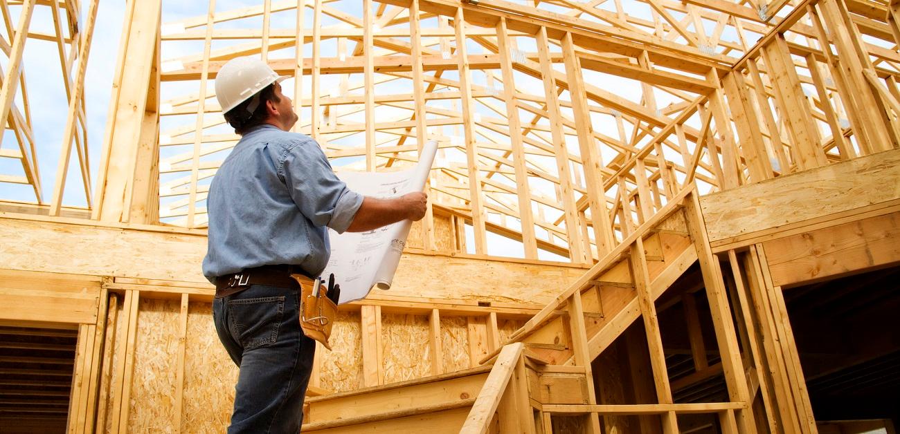 Home inspector surveying new construction