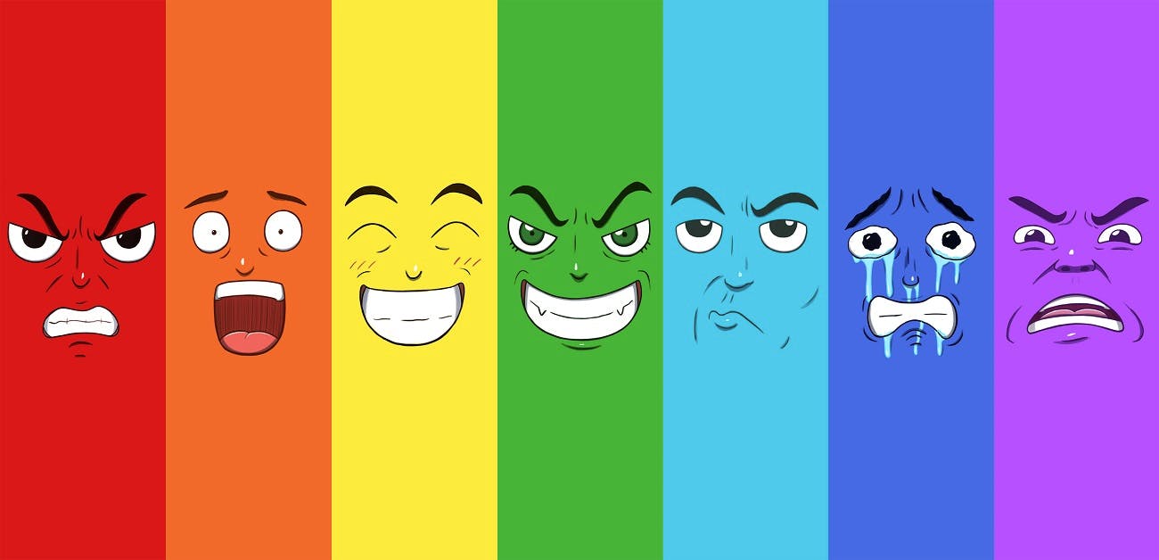 Set of seven faces expressing different emotions in a rainbow pattern