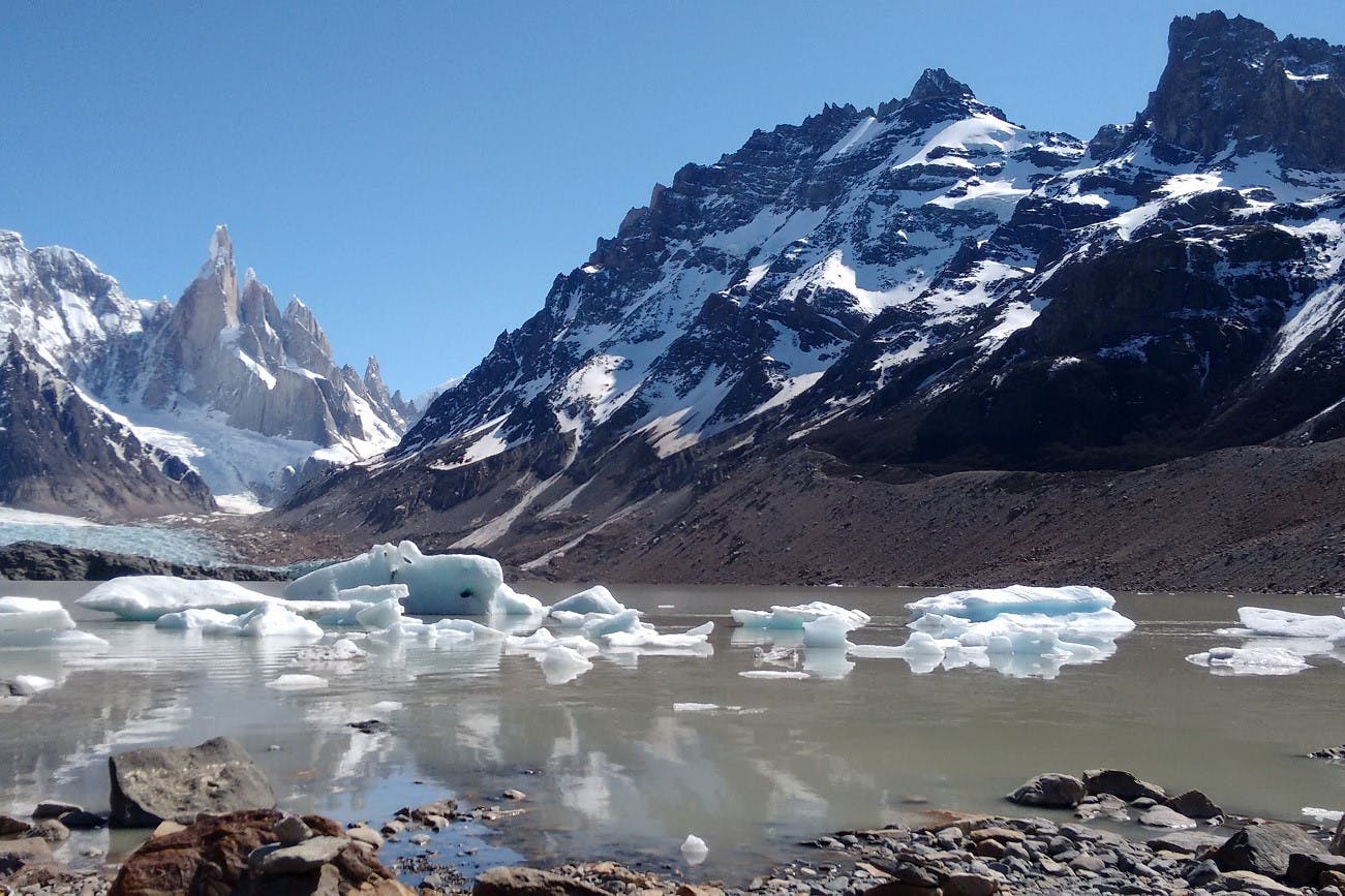 Melting frozen lake and snow covered mountains