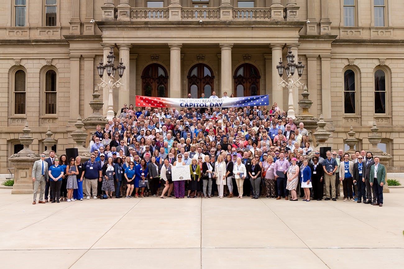 Michigan REALTORS® Capitol Day attendees on the steps of the refurbished capitol building in Lansing.