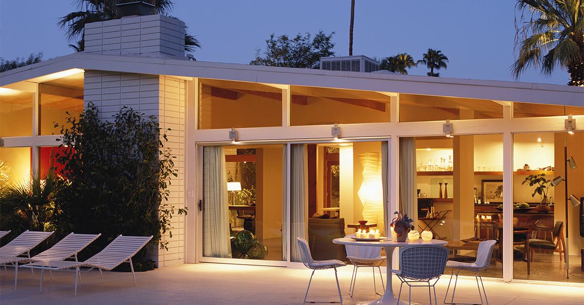 Modern house exterior at dusk, with patio