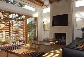 Living room of house with open wood shades