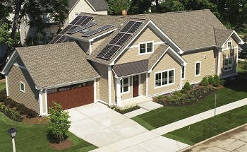 Aerial view of a house with solar panels on the roof