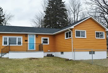 Beige house after renovation now painted orange