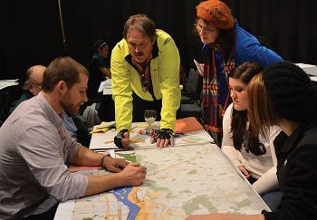 People sitting around a table looking at a map