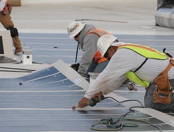 Workers installing solar panels