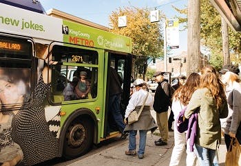 A bus in Seattle picking up passengers at a bus stop