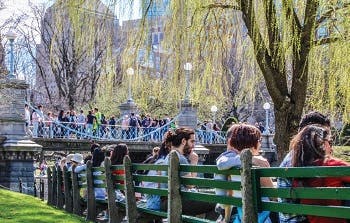 People sitting on benches at a square