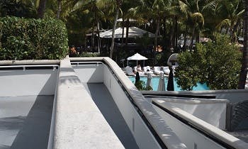 A two-story handicap ramp in a condominium in Miami Beach leading to a pool area