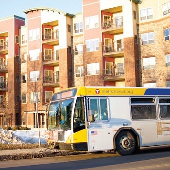 Minneapolis commuter bus near a residential apartment building