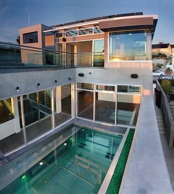 A two-level home with a pool on the ground floor