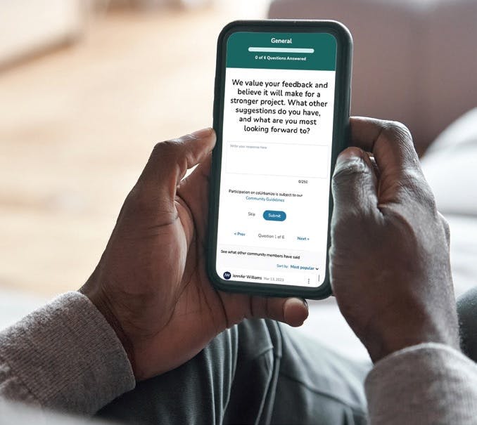 Black man holding his smart phone displaying an engagement message