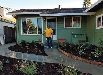 African American woman in front of her front yard