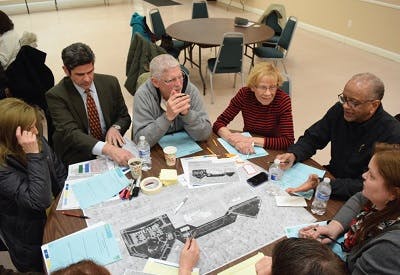 Meeting with several people sitting at a round table