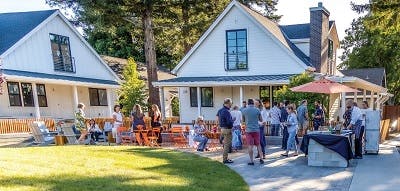 A neighborhood party, neighbors congregate in front of their houses