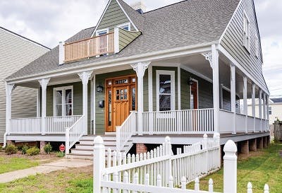 Brand new home with an all-around porch and front yard