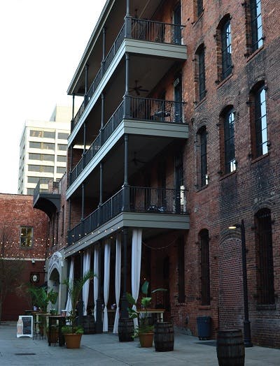 Three story brick building with balconies