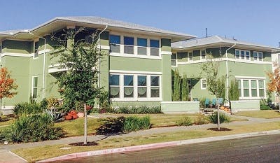 Two-story green apartment building complex