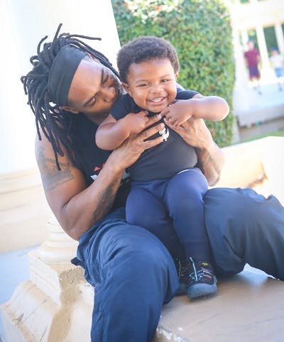 African american father holding his son