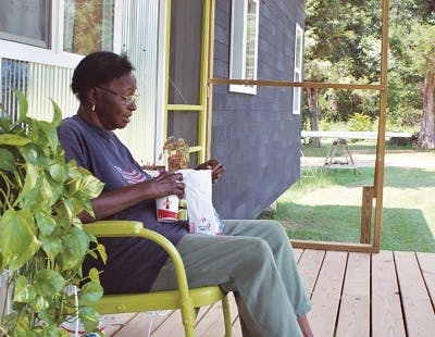 African american woman sitting on front porch