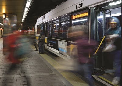 People getting off the bus at a Boston bus terminal