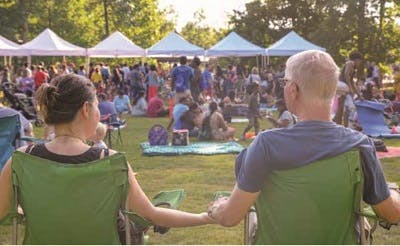 A couple enjoys festivities during Kids to Parks Day at Brook Run Park in Dunwoody, GA