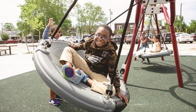 Kids having fun on a playground swing 