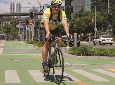 Man riding bicycle on bike lane