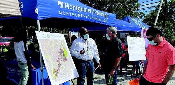 Community gathering in front of Montgomery County Planning blue tents 