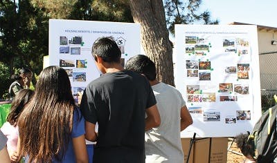 Kids looking at housing benefits poster