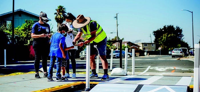 Toole Design staff engaged with residents in San Pablo, CA, as they experienced a temporary floating bus stop