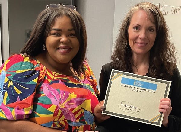 Participant holding the Transit Citizen Leadership Academy certificate