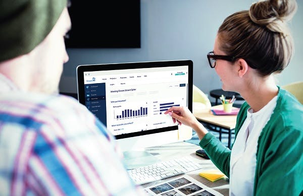 Woman showing a graphic on a laptop screen